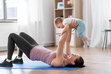 Image showing happy mother with little baby exercising at home