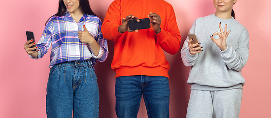 Image showing Group of friends using mobile smartphones. Teenagers addiction to new technology trends. Close up.