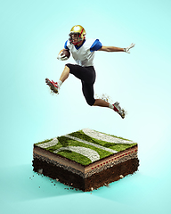 Image showing American football player on blue background above stadium layers. Professional sportsman during game playing in action and motion.