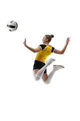 Image showing Young female volleyball player isolated on white studio background. Woman in sport\'s equipment training and practicing.