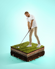 Image showing Golf player in a white shirt playing on blue background above stadium layers. Professional player practicing during gameplay, championship