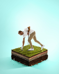 Image showing Golf player in a white shirt playing on blue background above stadium layers. Professional player practicing during gameplay, championship