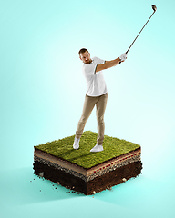 Image showing Golf player in a white shirt playing on blue background above stadium layers. Professional player practicing during gameplay, championship