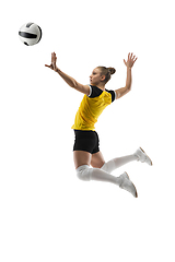 Image showing Young female volleyball player isolated on white studio background. Woman in sport\'s equipment training and practicing.