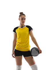 Image showing Young female volleyball player isolated on white studio background. Woman in sport\'s equipment training and practicing.