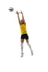 Image showing Young female volleyball player isolated on white studio background. Woman in sport\'s equipment training and practicing.