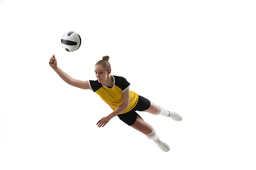 Image showing Young female volleyball player isolated on white studio background. Woman in sport\'s equipment training and practicing.