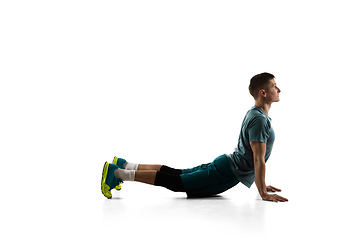 Image showing Young caucasian male model in action, motion isolated on white background. Concept of sport, movement, energy and dynamic, healthy lifestyle. Training, practicing.