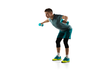 Image showing Young caucasian male model in action, motion isolated on white background. Concept of sport, movement, energy and dynamic, healthy lifestyle. Training, practicing.