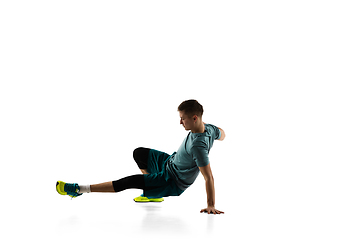 Image showing Young caucasian male model in action, motion isolated on white background. Concept of sport, movement, energy and dynamic, healthy lifestyle. Training, practicing.