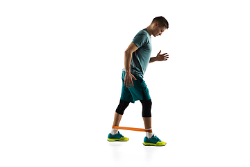 Image showing Young caucasian male model in action, motion isolated on white background. Concept of sport, movement, energy and dynamic, healthy lifestyle. Training, practicing.