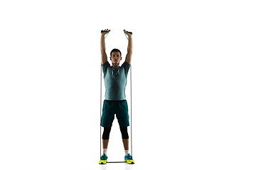 Image showing Young caucasian male model in action, motion isolated on white background. Concept of sport, movement, energy and dynamic, healthy lifestyle. Training, practicing.