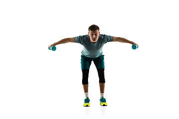 Image showing Young caucasian male model in action, motion isolated on white background. Concept of sport, movement, energy and dynamic, healthy lifestyle. Training, practicing.