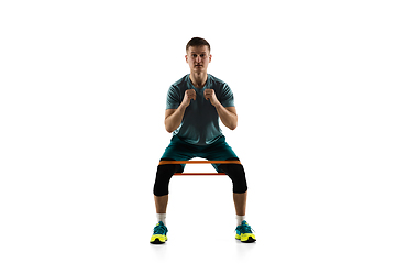 Image showing Young caucasian male model in action, motion isolated on white background. Concept of sport, movement, energy and dynamic, healthy lifestyle. Training, practicing.