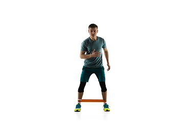 Image showing Young caucasian male model in action, motion isolated on white background. Concept of sport, movement, energy and dynamic, healthy lifestyle. Training, practicing.