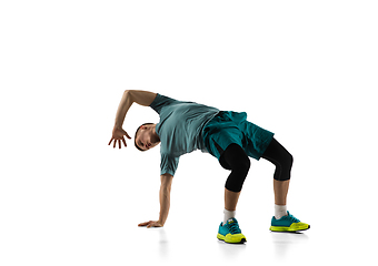 Image showing Young caucasian male model in action, motion isolated on white background. Concept of sport, movement, energy and dynamic, healthy lifestyle. Training, practicing.