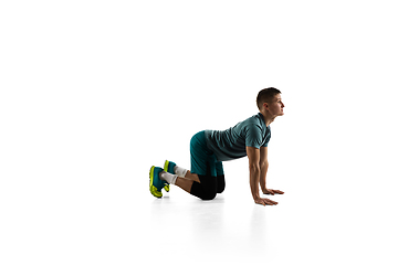 Image showing Young caucasian male model in action, motion isolated on white background. Concept of sport, movement, energy and dynamic, healthy lifestyle. Training, practicing.