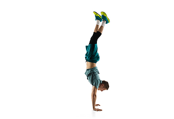 Image showing Young caucasian male model in action, motion isolated on white background. Concept of sport, movement, energy and dynamic, healthy lifestyle. Training, practicing.