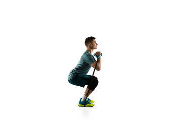 Image showing Young caucasian male model in action, motion isolated on white background. Concept of sport, movement, energy and dynamic, healthy lifestyle. Training, practicing.