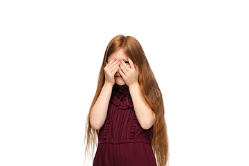 Image showing Happy caucasian little girl isolated on white studio background. Looks happy, cheerful, sincere. Copyspace. Childhood, education, emotions concept