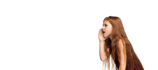 Image showing Happy caucasian little girl isolated on white studio background. Looks happy, cheerful, sincere. Copyspace. Childhood, education, emotions concept