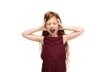 Image showing Happy caucasian little girl isolated on white studio background. Looks happy, cheerful, sincere. Copyspace. Childhood, education, emotions concept