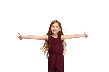 Image showing Happy caucasian little girl isolated on white studio background. Looks happy, cheerful, sincere. Copyspace. Childhood, education, emotions concept