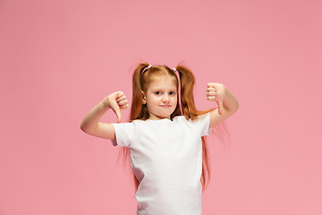 Image showing Happy caucasian little girl isolated on pink studio background. Looks happy, cheerful, sincere. Copyspace. Childhood, education, emotions concept