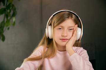 Image showing Little girl wearing headphones during online education course, lesson, view of screen