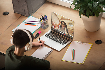 Image showing Little boy studying by group video call, use video conference with teacher, listening to online course