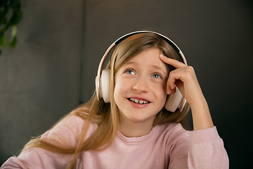 Image showing Little girl wearing headphones during online education course, lesson, view of screen