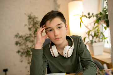 Image showing Little boy wearing headphones during online education course, lesson, view of screen