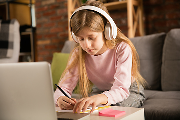 Image showing Little girl studying by group video call, use video conference with teacher, listening to online course