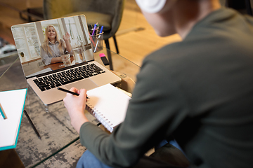 Image showing Little boy studying by group video call, use video conference with teacher, listening to online course