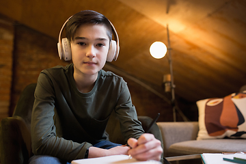 Image showing Little boy wearing headphones during online education course, lesson, view of screen