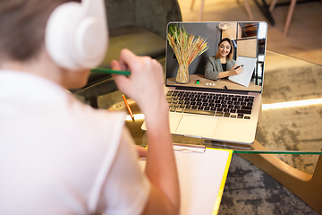 Image showing Little boy studying by group video call, use video conference with teacher, listening to online course