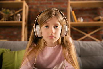 Image showing Little girl wearing headphones during online education course, lesson, view of screen