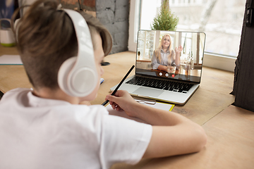 Image showing Little boy studying by group video call, use video conference with teacher, listening to online course