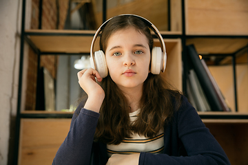 Image showing Little girl wearing headphones during online education course, lesson, view of screen