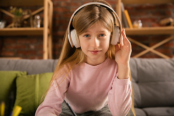 Image showing Little girl wearing headphones during online education course, lesson, view of screen