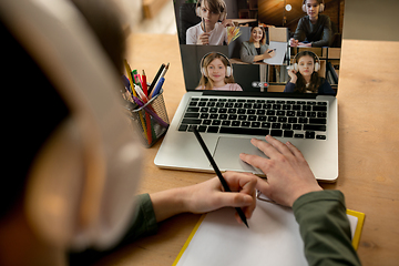 Image showing Little boy studying by group video call, use video conference with teacher, listening to online course