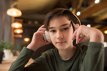 Image showing Little boy wearing headphones during online education course, lesson, view of screen