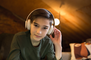 Image showing Little boy wearing headphones during online education course, lesson, view of screen