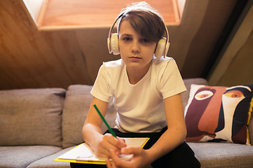 Image showing Little boy view studying by group video call, use video conference with teacher, listening to online course