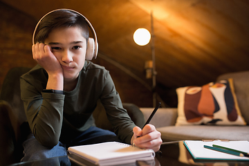 Image showing Little boy wearing headphones during online education course, lesson, view of screen