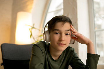 Image showing Little boy wearing headphones during online education course, lesson, view of screen