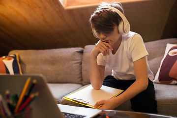 Image showing Little boy studying by group video call, use video conference with teacher, listening to online course