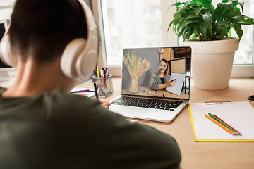 Image showing Little boy studying by group video call, use video conference with teacher, listening to online course