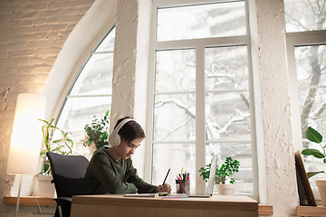 Image showing Little boy wearing headphones during online education course, lesson, view of screen