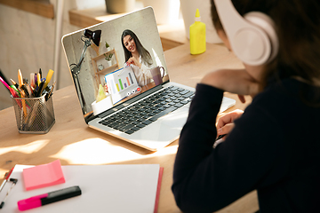 Image showing Little girl studying by group video call, use video conference with teacher, listening to online course